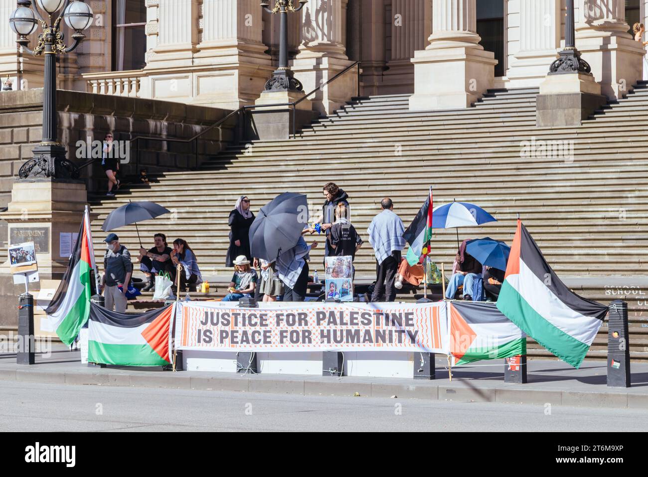 MELBOURNE, AUSTRALIA - NOVEMBER 11, 2023: Protestors gather to support Palestine in the war against Israel on the steps of Parliament in Spring St, in Stock Photo