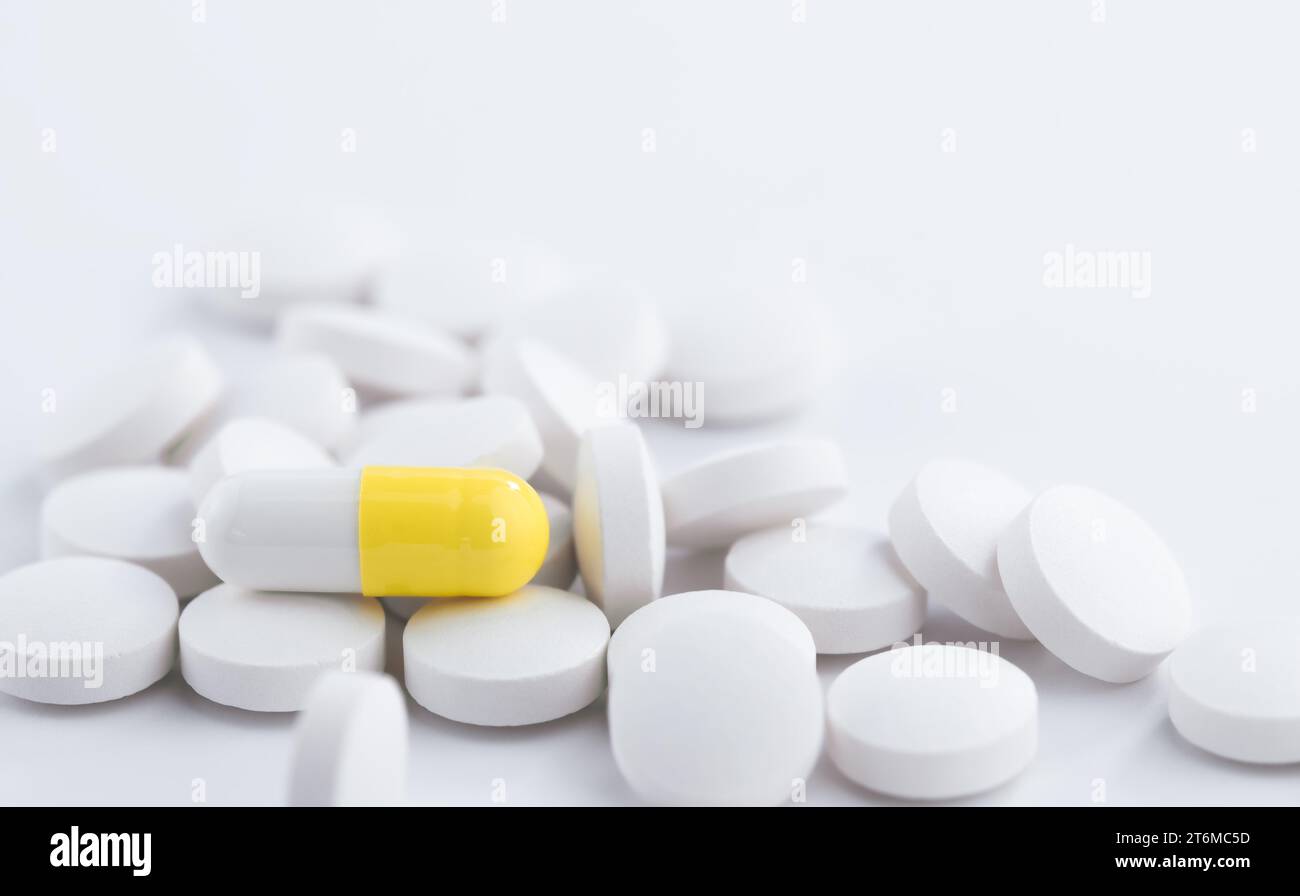 White and yellow medicine tablets antibiotic pills, pharmacy theme. Stock Photo