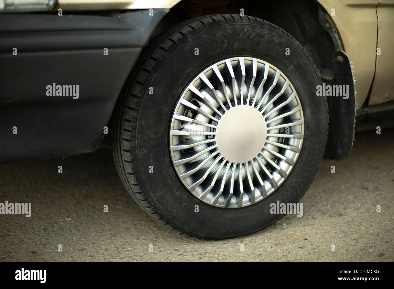 Car wheel. Hubcap on wheel. Vehicle tuning details. Drive wheel. Retro style. Black tire. Stock Photo