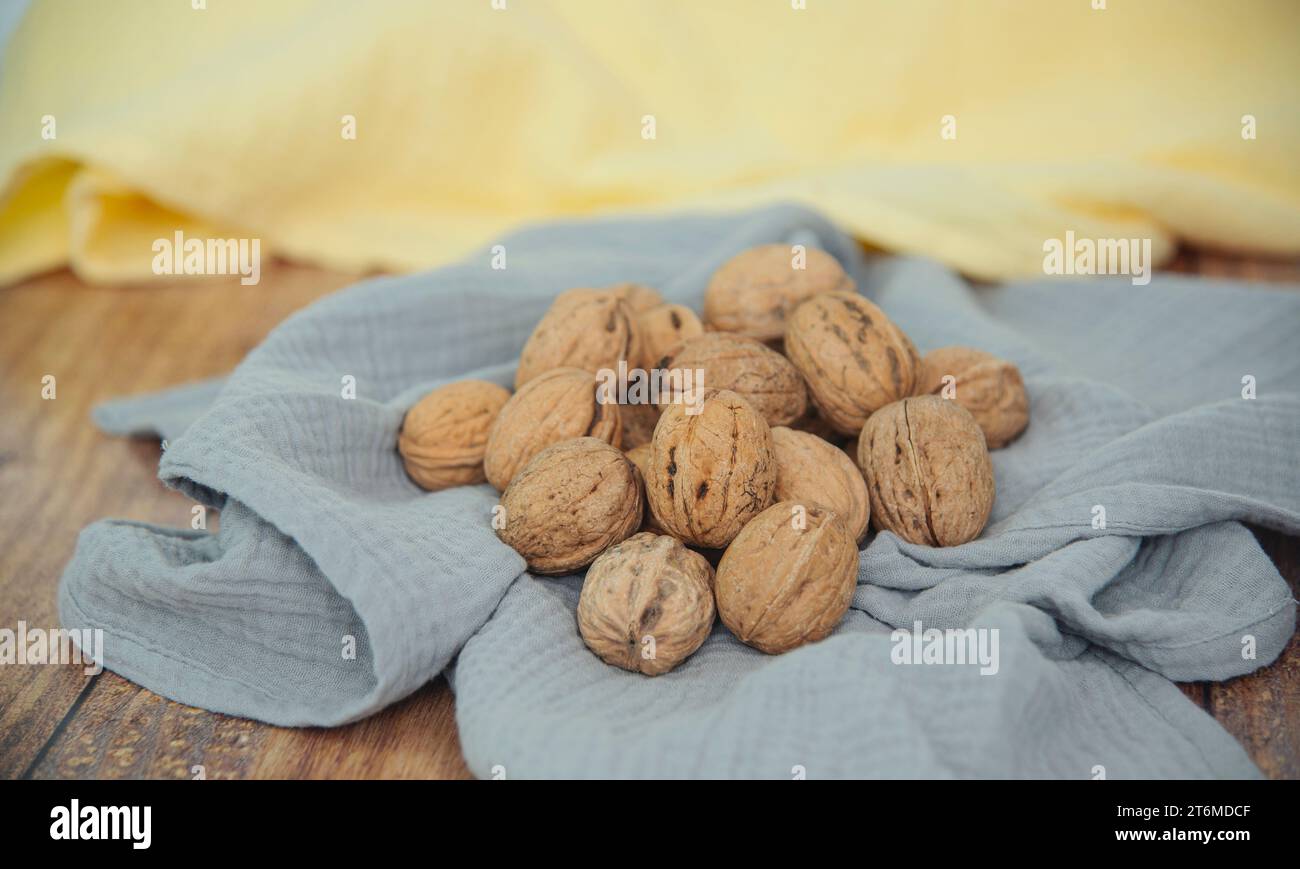 Food background. Walnut kernels close-up. Chopped nuts lie on a table. Stock Photo
