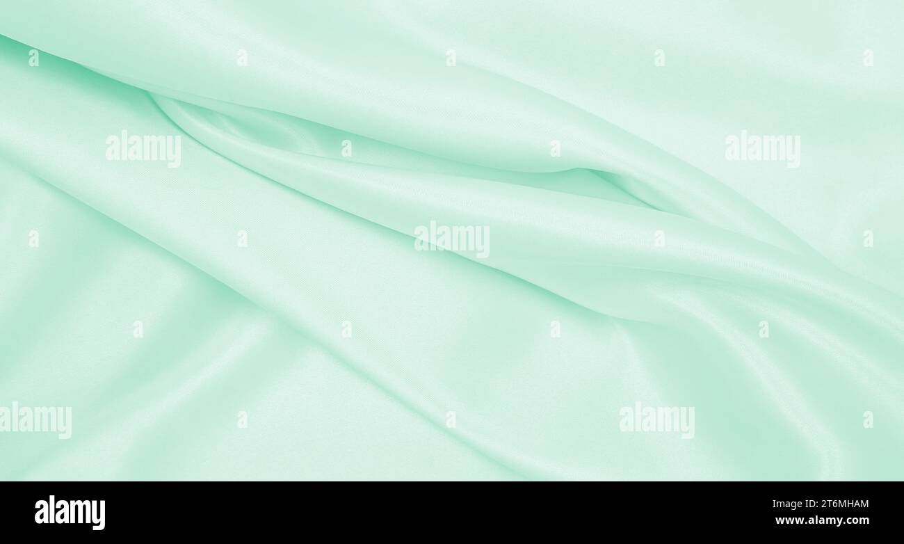 Smooth elegant green silk or satin luxury cloth texture can use as ...