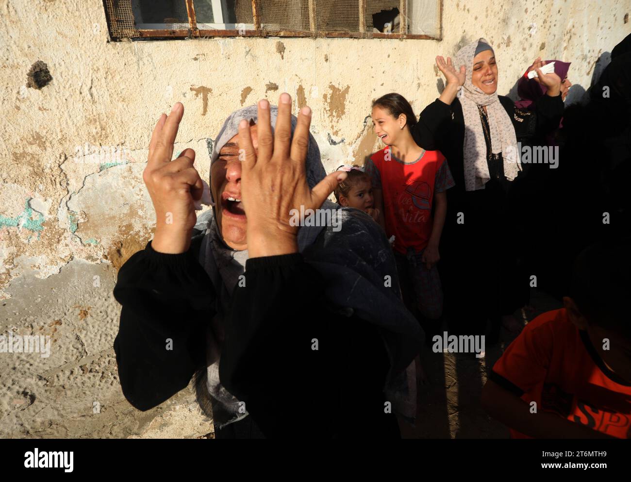 Women react during the funeral of the Faojo family, killed in Israeli