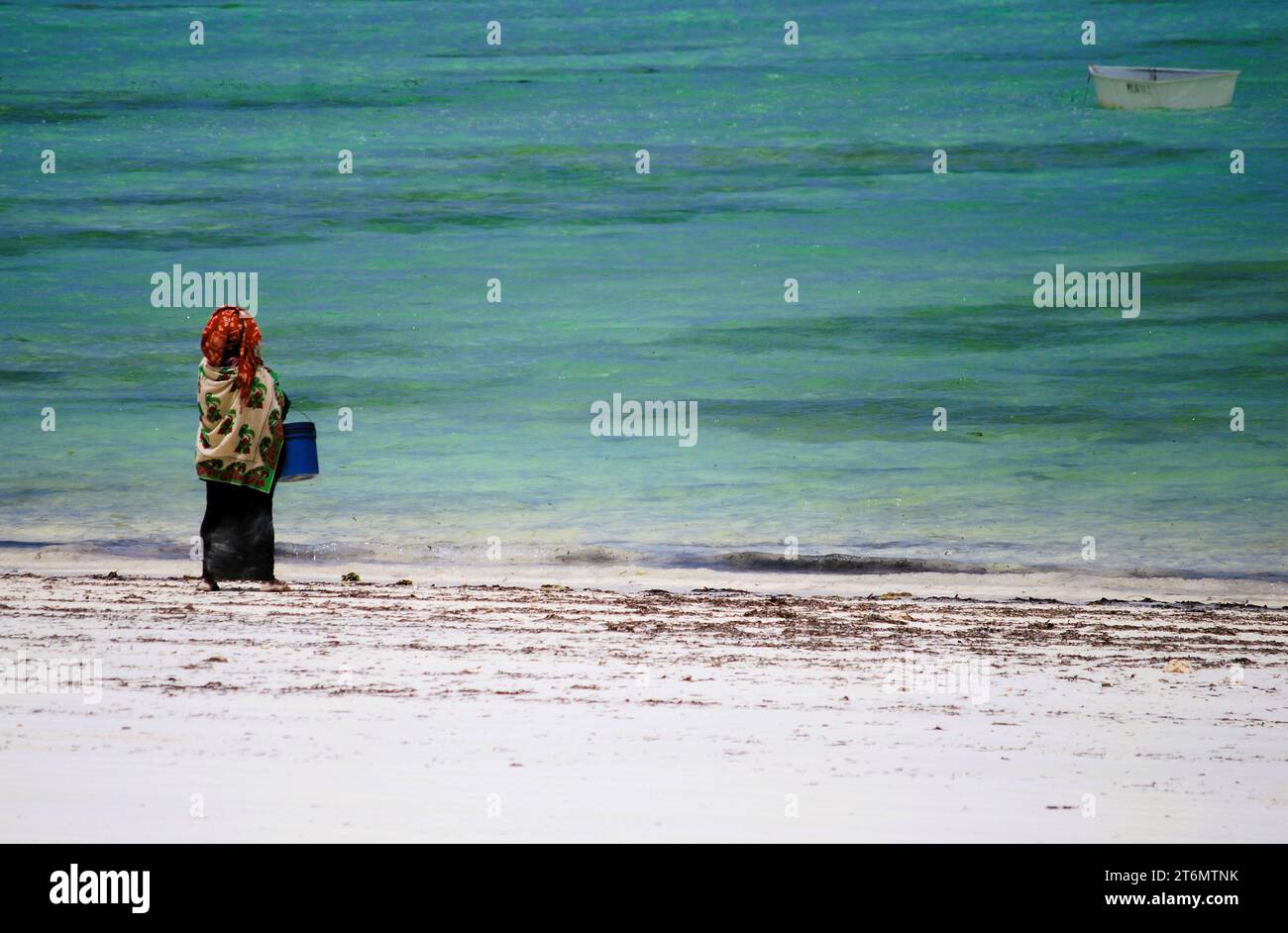 Local Zanzibar Woman on the Beach, in traditional dress, Paje Beach, Zanzibar, Unguja, Tanzania Stock Photo