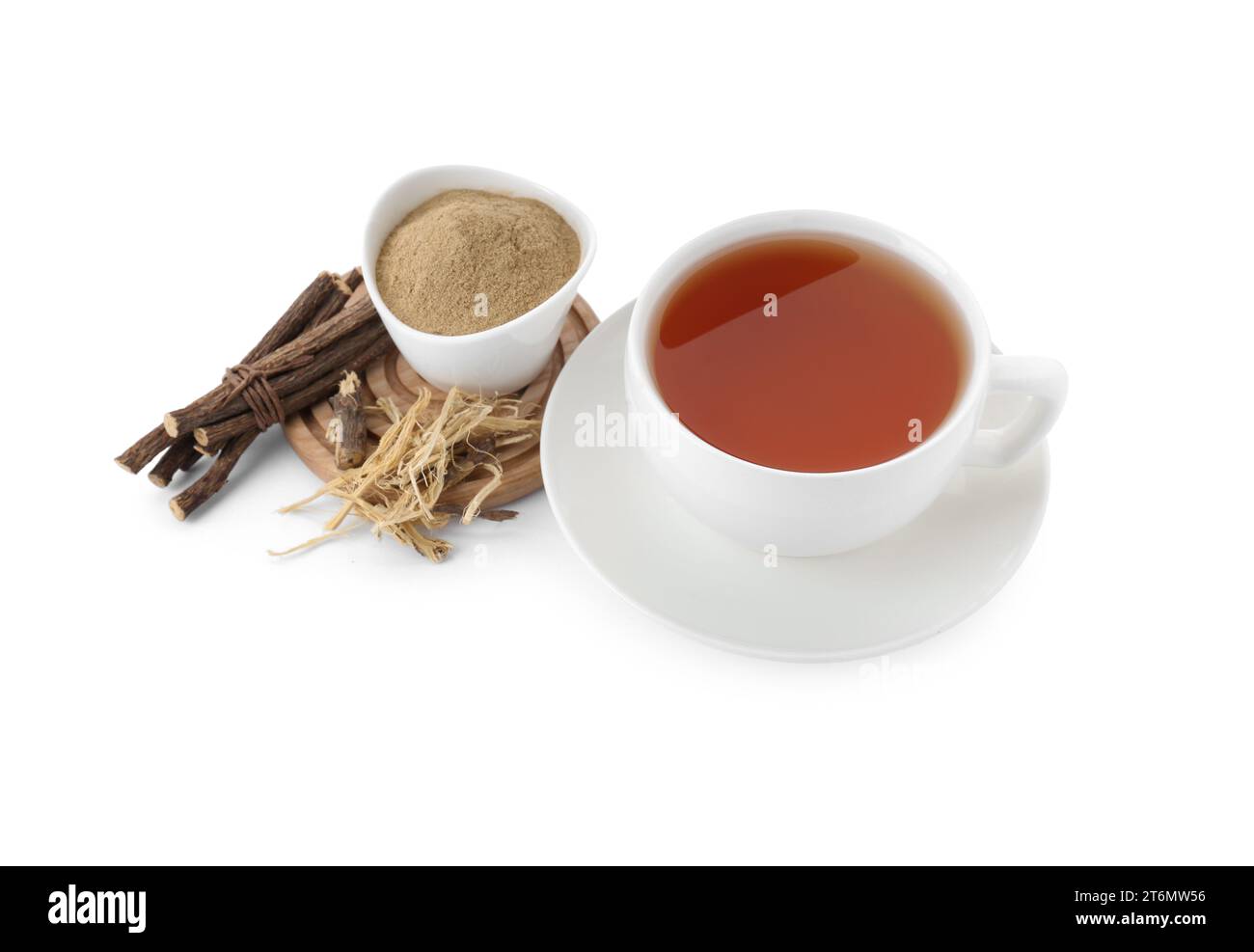 Aromatic licorice tea in cup, dried sticks of licorice root and powder