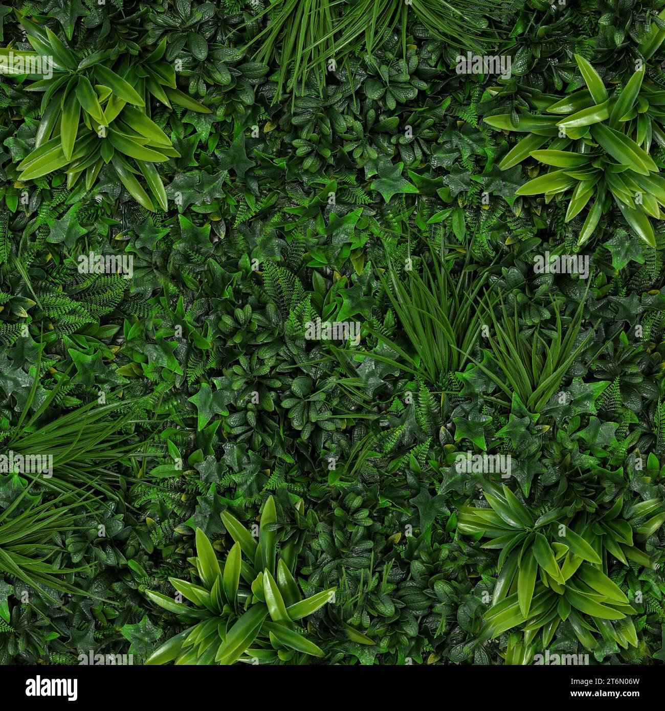Lush bright green artificial plants as background Stock Photo Alamy