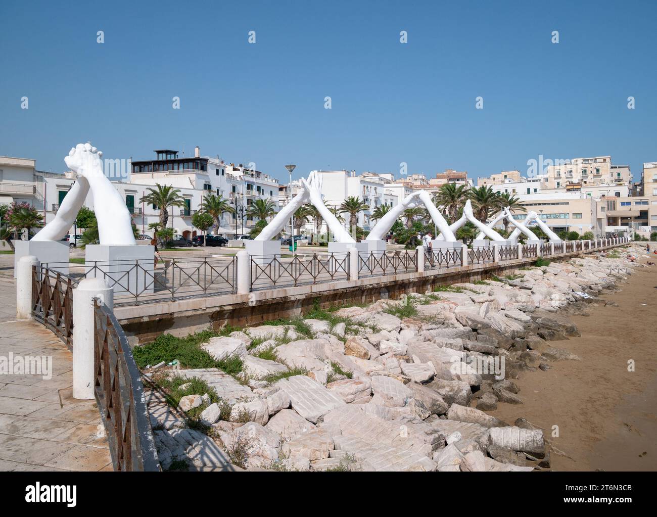 Vieste, Italy - 25 August 2023:View of Building Bridges, six pairs of giant hands, 15 meters high and joined, in the heart of Vieste on the Marina Pic Stock Photo