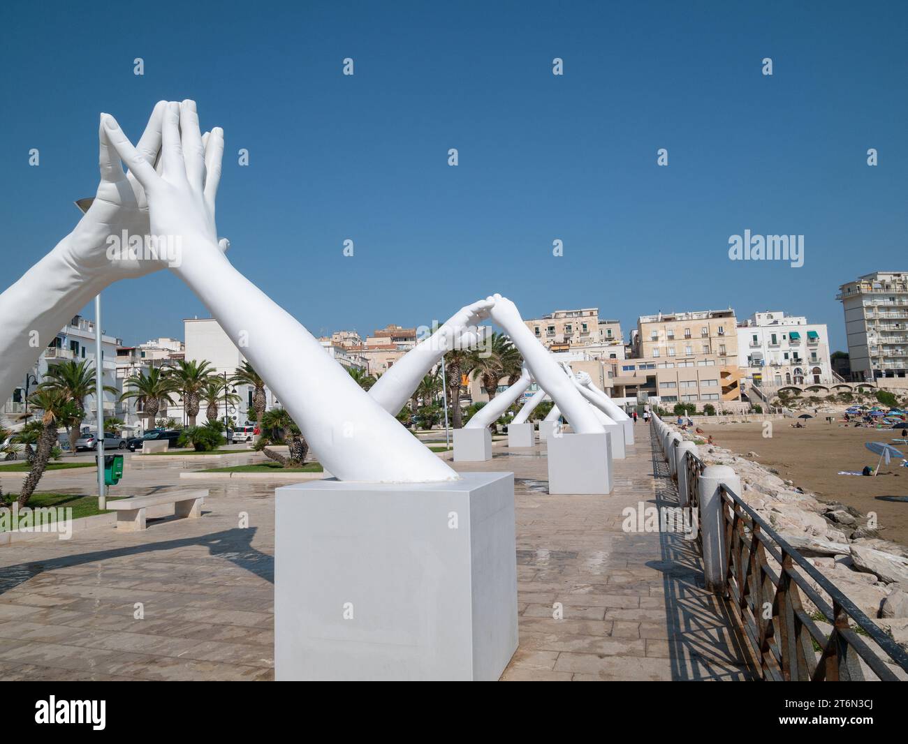 Vieste, Italy - 25 August 2023:View of Building Bridges, six pairs of giant hands, 15 meters high and joined, in the heart of Vieste on the Marina Pic Stock Photo