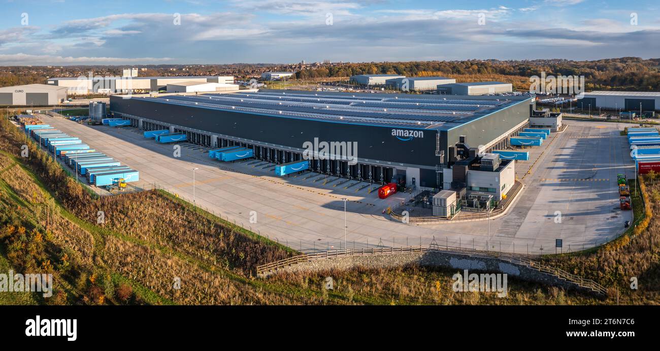 LEEDS, UK - NOVEMBER 9, 2023.  Aerial landscape of a large Amazon distribution or fulfilment warehouse with trucks and trailers loading and unloading Stock Photo
