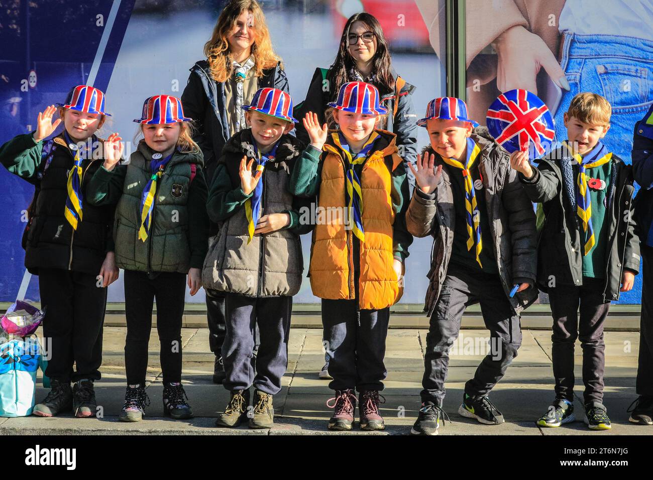 London, UK 11th Nov 2023. The 1st Coulsdon Scout Group cheer on the parade. This year's Lord Mayor's Show brings together 7,000 people, including charities, community groups, the armed forces, 250 horses, and over 150 floats in a three-mile-long parade, including the golden State Coach with new Lord Mayor Michael Mainelli. Stock Photo