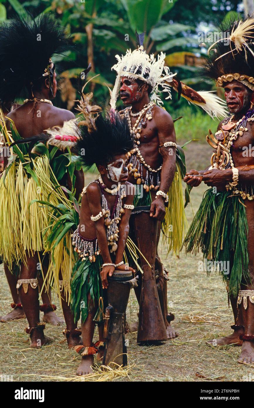 Papua New Guinea. East Sepik. Sepik River Crocodile and Arts Festival. Local tribesmen & boy with drums. Stock Photo