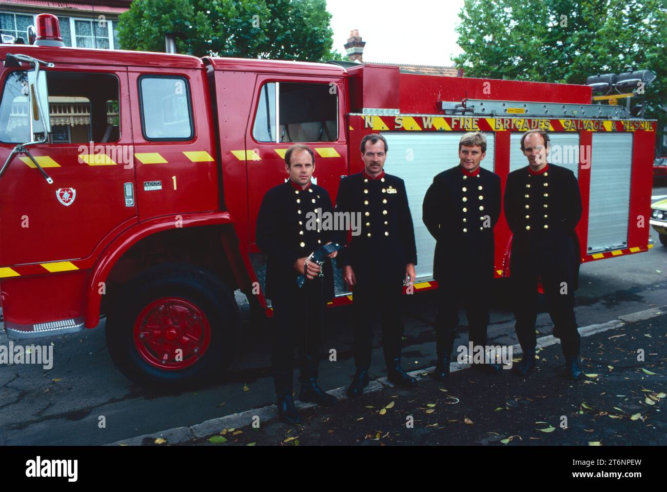 Australia. New South Wales. Occupations. Firemen standing in front of fire engine. Stock Photo