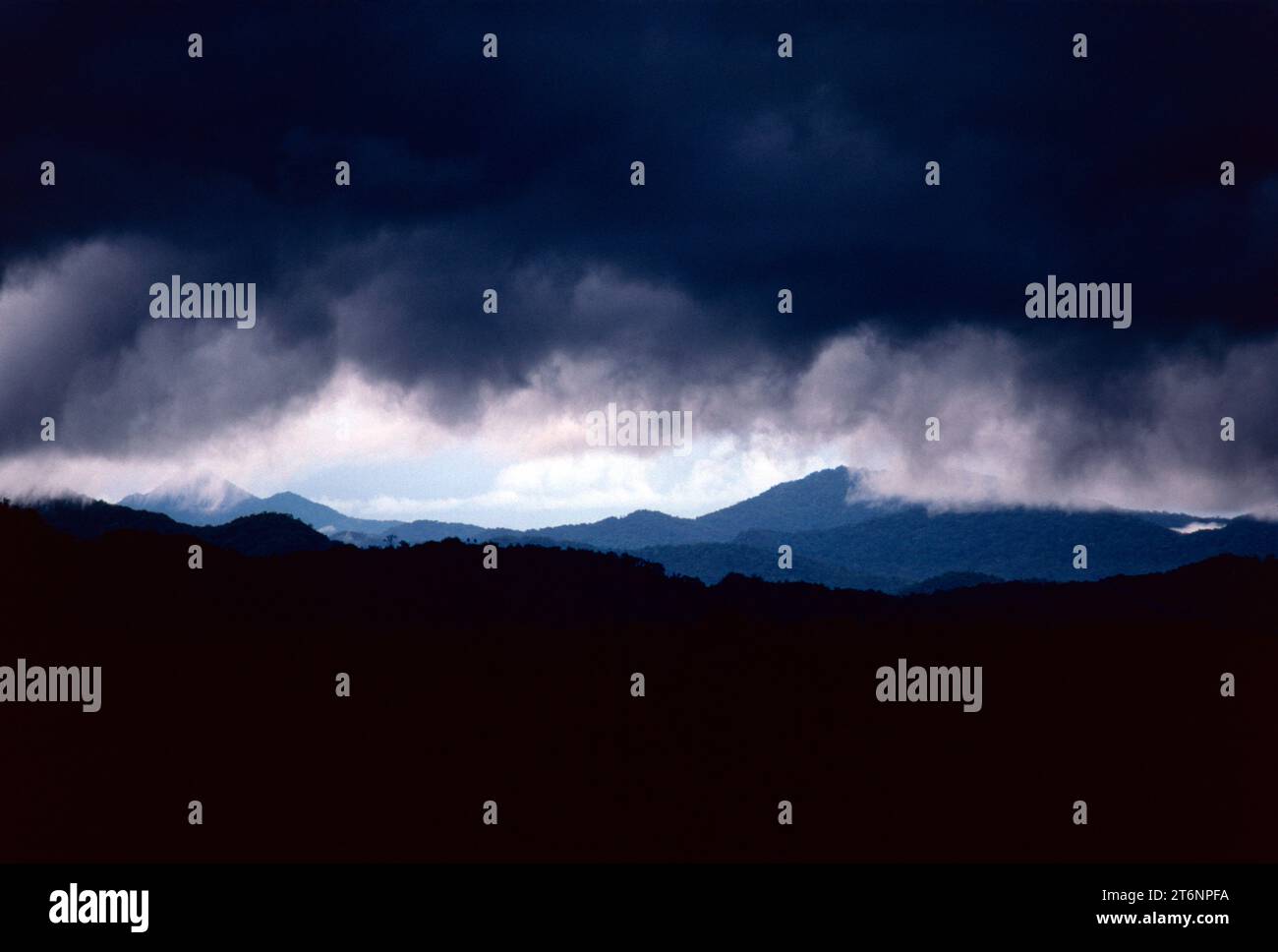 Papua New Guinea. Highlands. View of mountains with dark storm clouds. Stock Photo