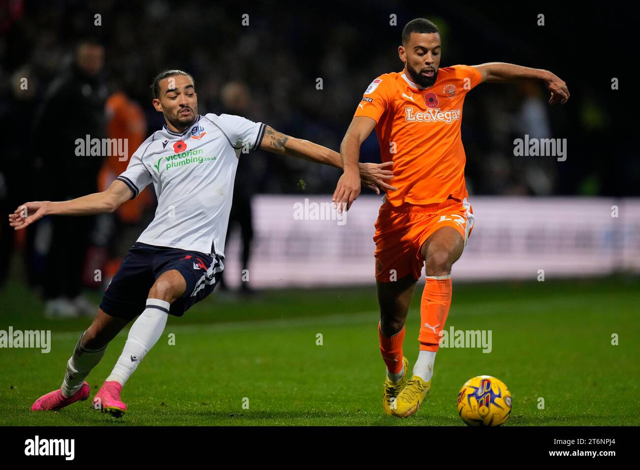 Randell Williams #27 of Bolton Wanderers competes for the ball with CJ ...