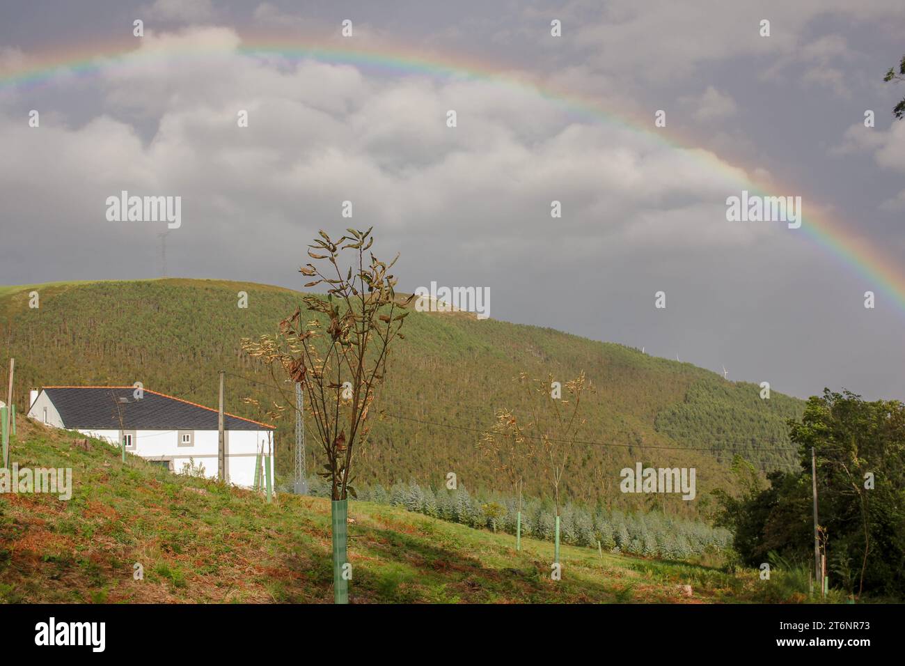 rainbow over the mountains in an autumn day with sun and rain Stock Photo