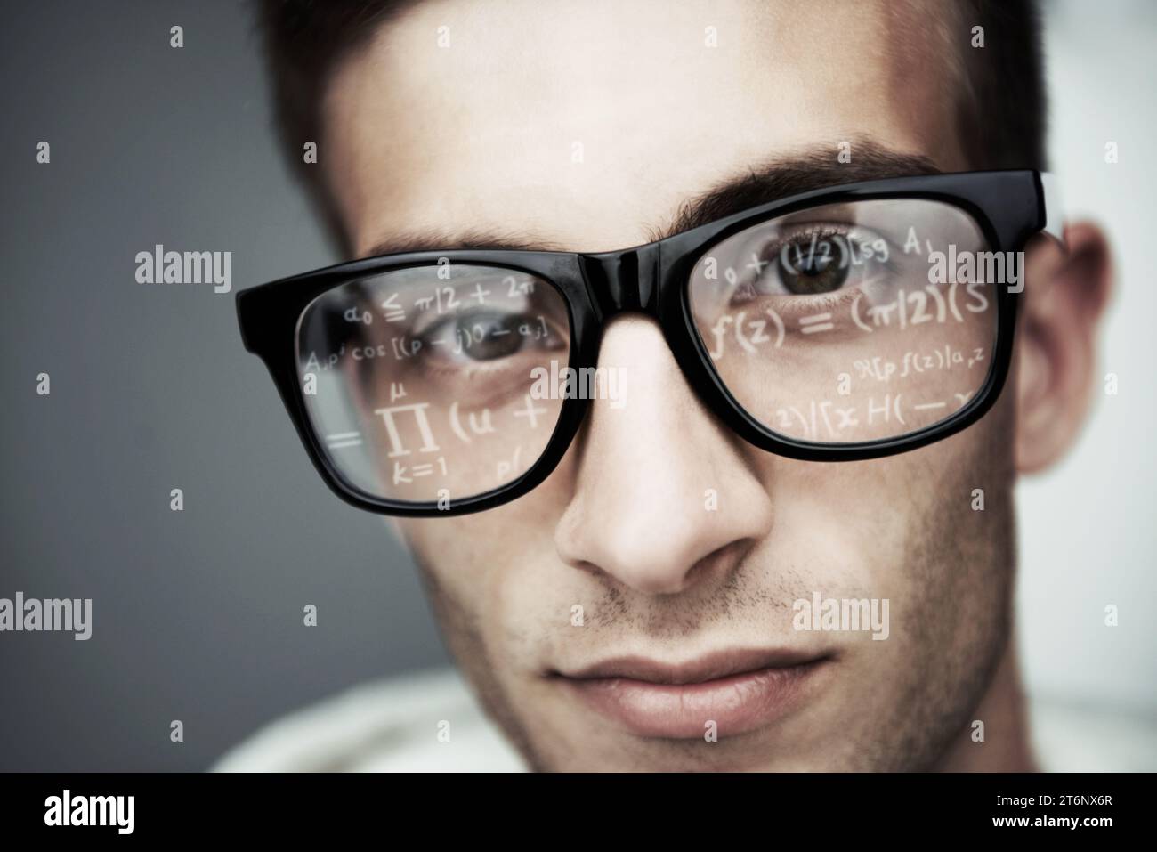 Portrait, glasses and formula with a man programmer closeup in studio on a gray background for support. Face, eyewear and software development with a Stock Photo