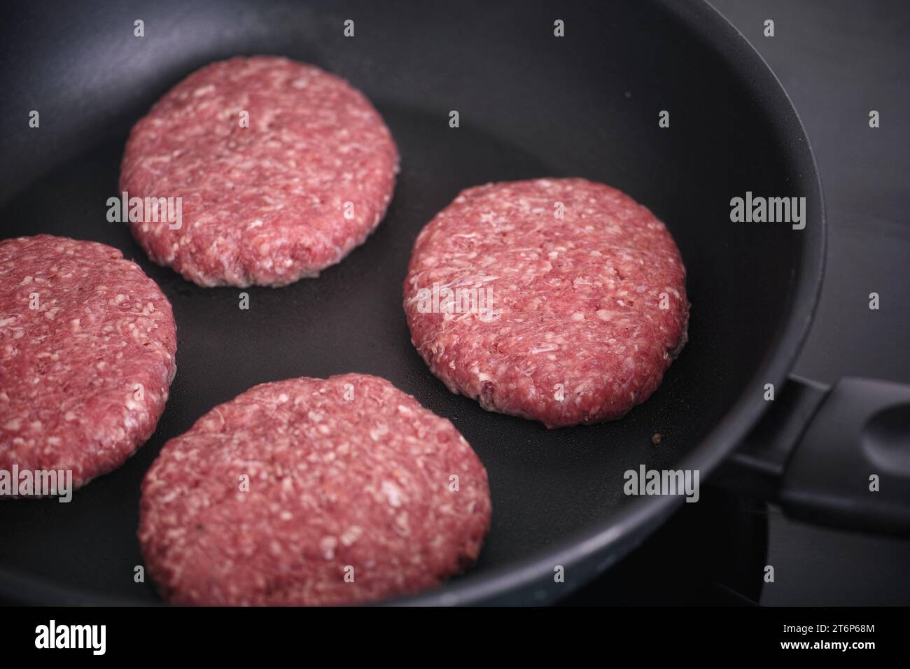 Beef patties cooking in a pan. Close up. Stock Photo