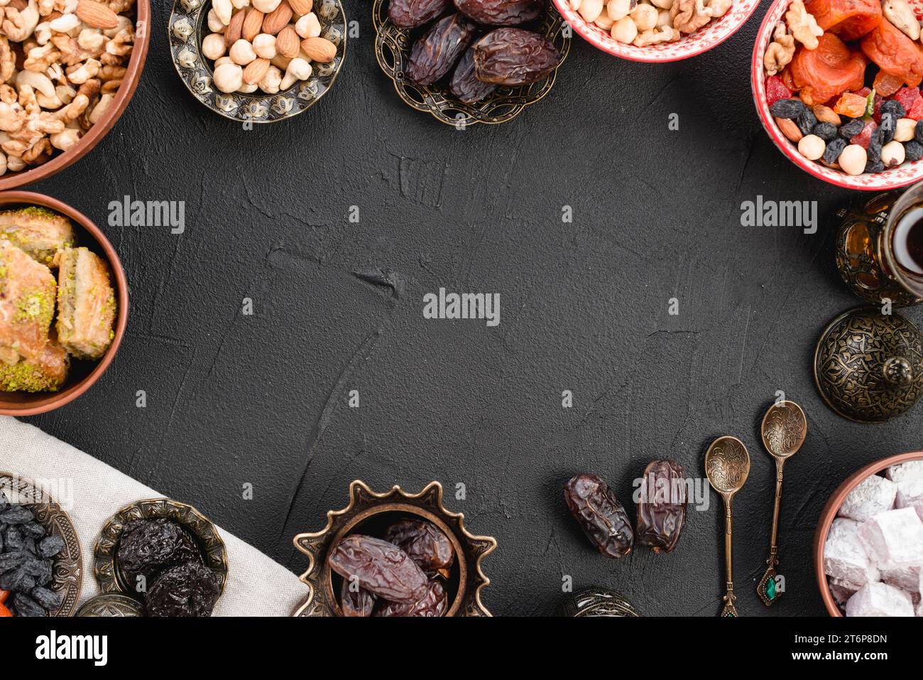 Juicy ripe dates nuts lukum baklava black concrete backdrop Stock Photo