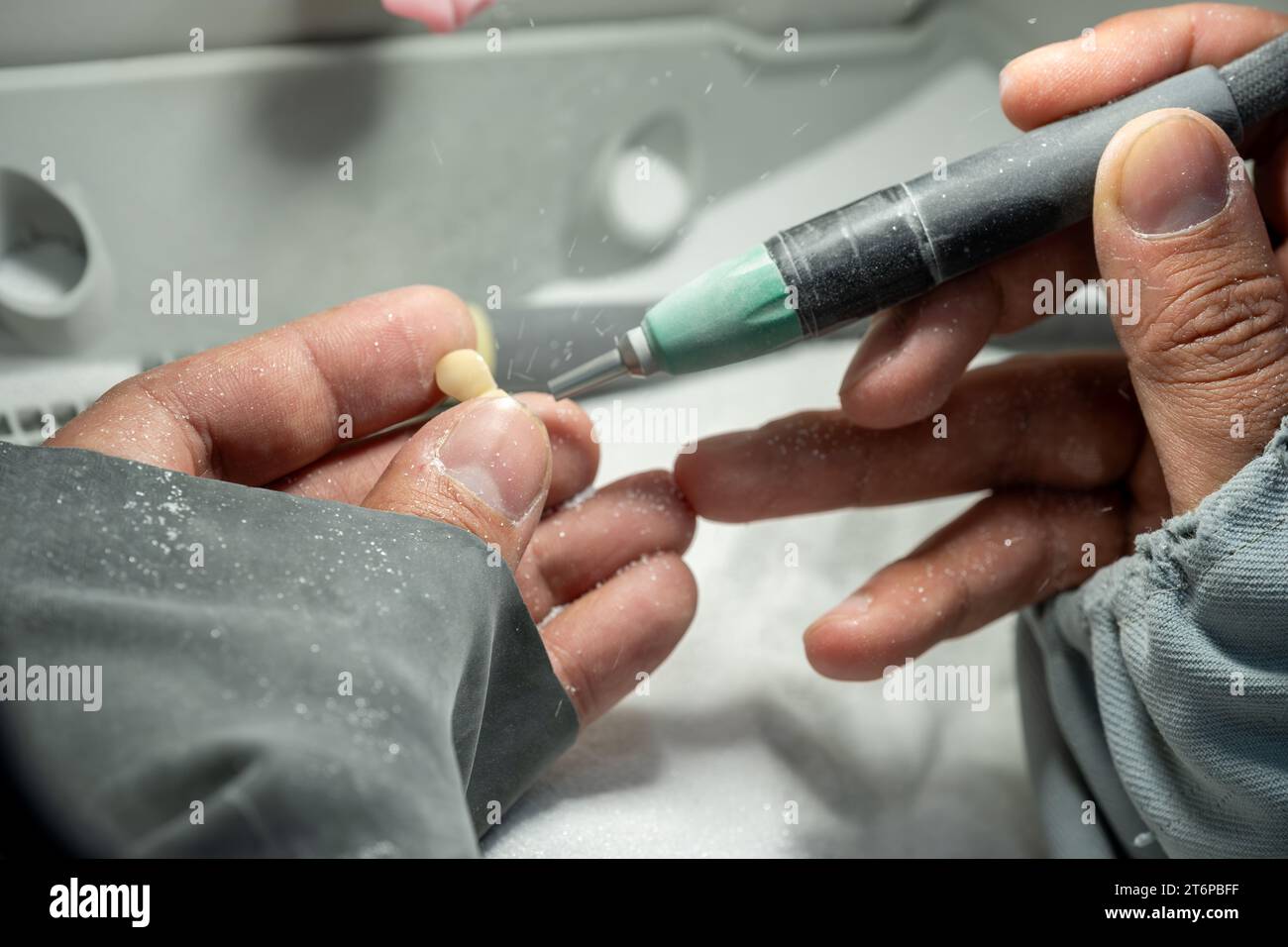 Sanding human tooth crowns to be fit and suitable for human needs Stock