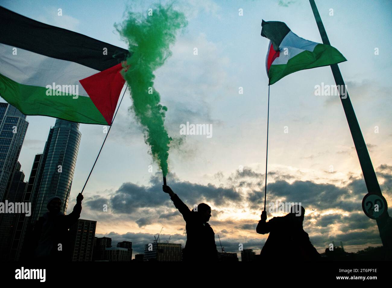 London, UK. 11 November, 2023. Flares are set off on Vauxhall Bridge at dusk as Palestine supporters march through London to U.S. Embassy. Stock Photo