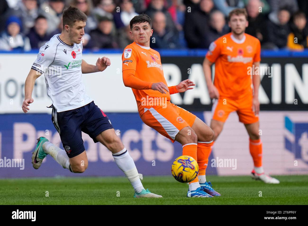 Albie 8 of Blackpool flicks the ball past Thomason 4 of