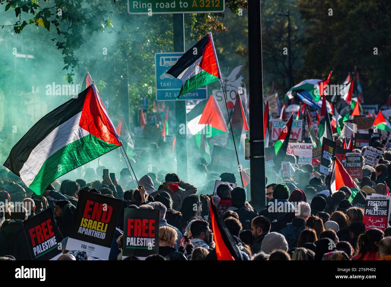 London, UK. 11 November, 2023. Flares are set of as 300,000 thousand Palestine supporters march through London from Hyde Park to U.S. Embassy. Stock Photo