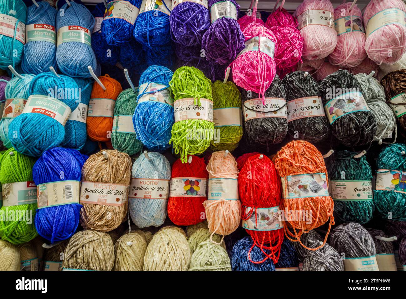 Italy - November 11, 2023: Colorful balls of yarn for  knitting displayed for sale in italian  haberdashery Stock Photo