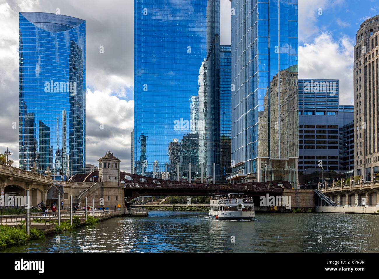 Architectural cruise on the Chicago River and reflection of skyscrapers. The bridges over the Chicago River are raised when necessary to allow larger ships to pass. The bridge keepers work in the historic bridge houses of Chicago, United States Stock Photo