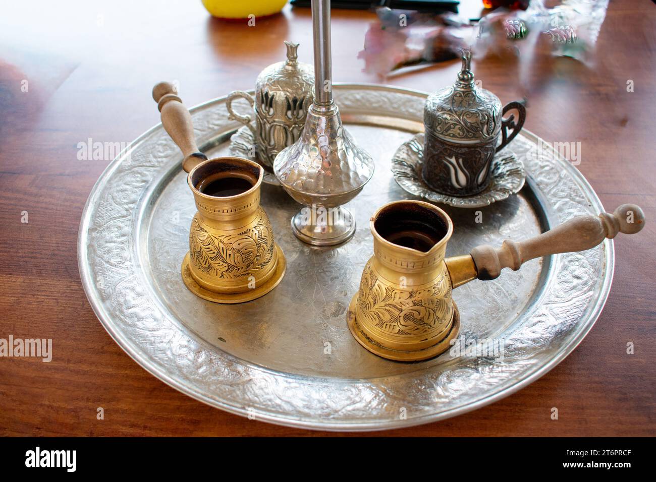 Traditional Tunisian Coffee, Closeup of ornamental decorative silver and gold cup and saucer with tea or coffee Stock Photo
