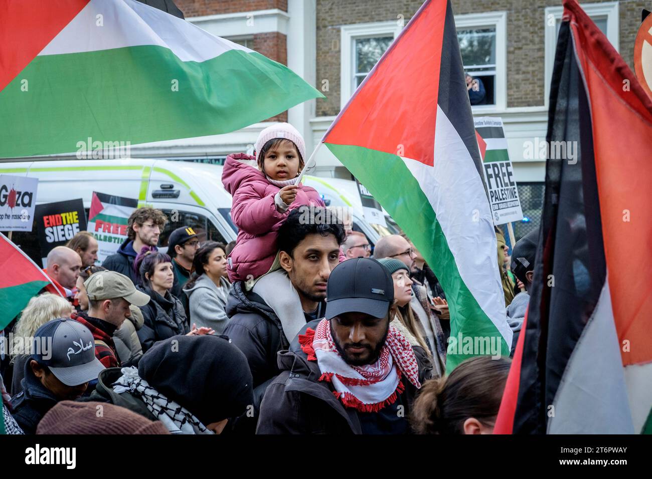 11th November 2023, London, UK. Hundreds of thousands of people march through central London in protest against Israel’s continued bombardment of Gaza. Organisers of the rally, the Palestine Solidarity Campaign, demand an immediate ceasefire. Pictured: A young girl carries a Palestine flag along the route of the march. Stock Photo