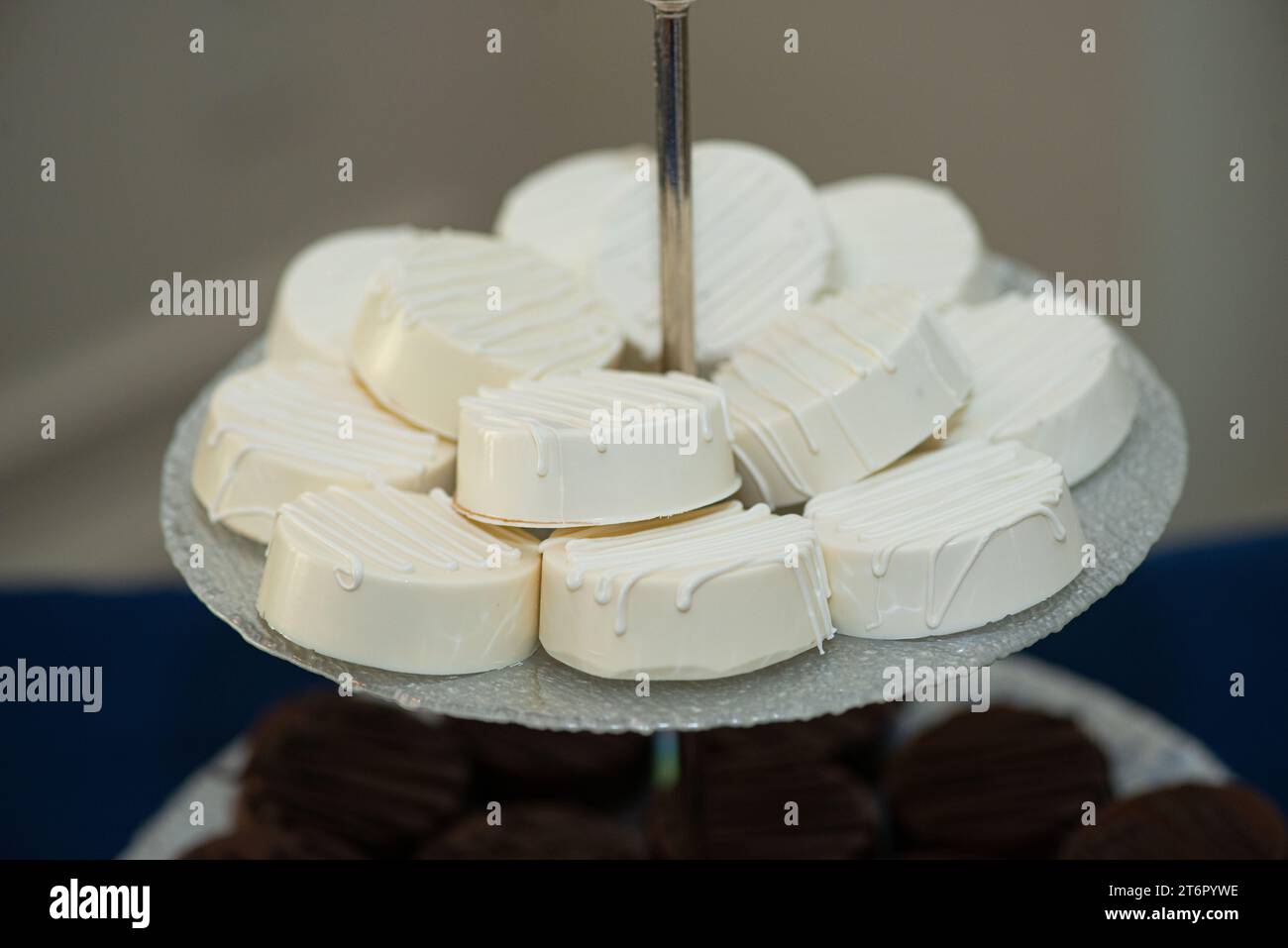 Vanilla Rounds Macadamia rounds covered in vanilla frosting on tray at dessert bar ...
