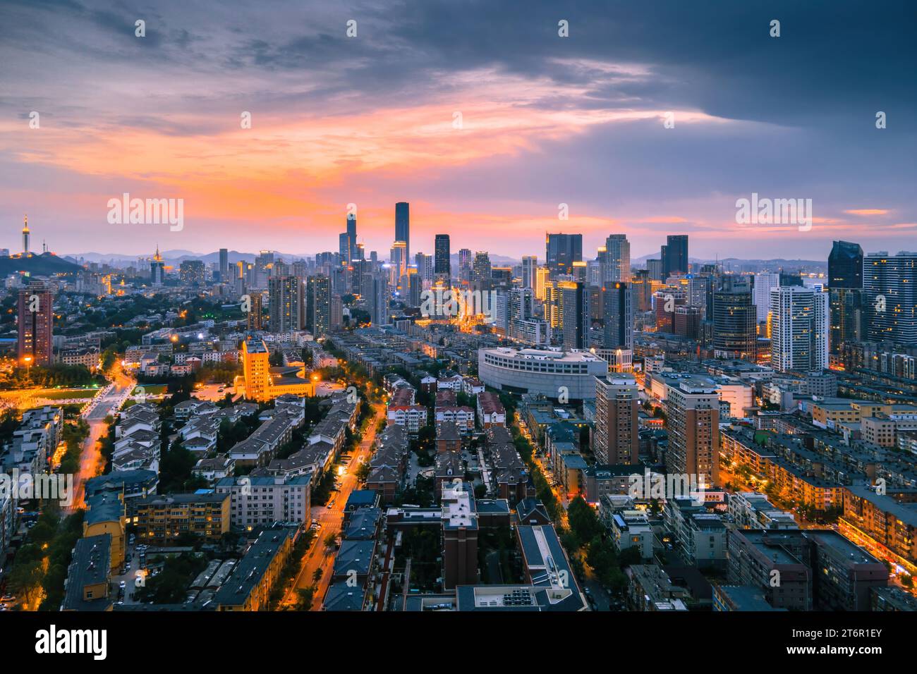 An aerial view of the stunning city skyline illuminated by the setting sun in Dalian, China Stock Photo