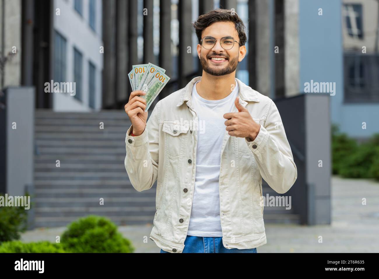 Happy Indian man counting money cash holding dollars banknotes, bills ...