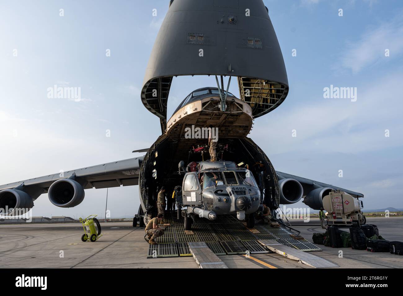 October 29, 2023 - Camp Lemonnier, Djibouti - U.S. Airmen with the 303rd Expeditionary Rescue Squadron load a U.S. Air Force HH-60W Jolly Green II into a C-5M Super Galaxy prior to redeploying at Camp Lemonnier, Djibouti, Oct. 29, 2023. In addition to the HH-60W, the C-5 was loaded with passengers returning to their home stations. (Credit Image: © U.S. Air Force/ZUMA Press Wire) EDITORIAL USAGE ONLY! Not for Commercial USAGE! Stock Photo