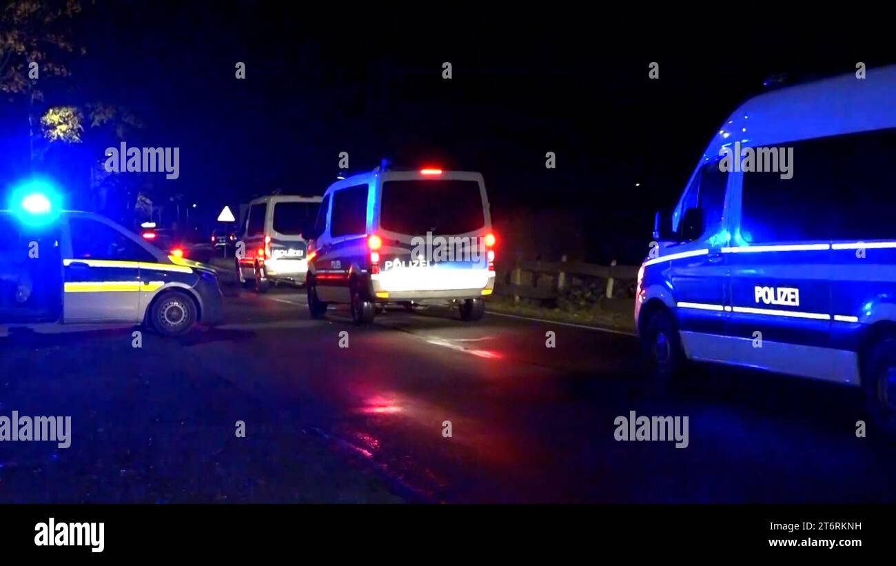 12 November 2023, Brandenburg, Vieritz: The video still shows police vehicles leaving the scene. After around 34 hours, a major police operation involving an armed man barricaded in a house in the Havelland district has come to an end. The suspect was found by the emergency services in the attic of the building in the municipality of Milower Land at around midnight on Sunday night, said a police spokeswoman. Photo: Christian Pörschmann/TNN/dpa Stock Photo