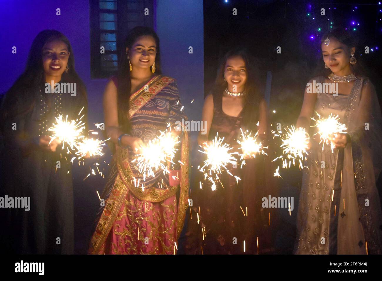 (231112) -- BHOPAL, Nov. 12, 2023 (Xinhua) -- Women play with firecrackers as they celebrate Diwali festival, also known as festival of lights, in Bhopal, India, Nov. 11, 2023. (Str/Xinhua) Stock Photo