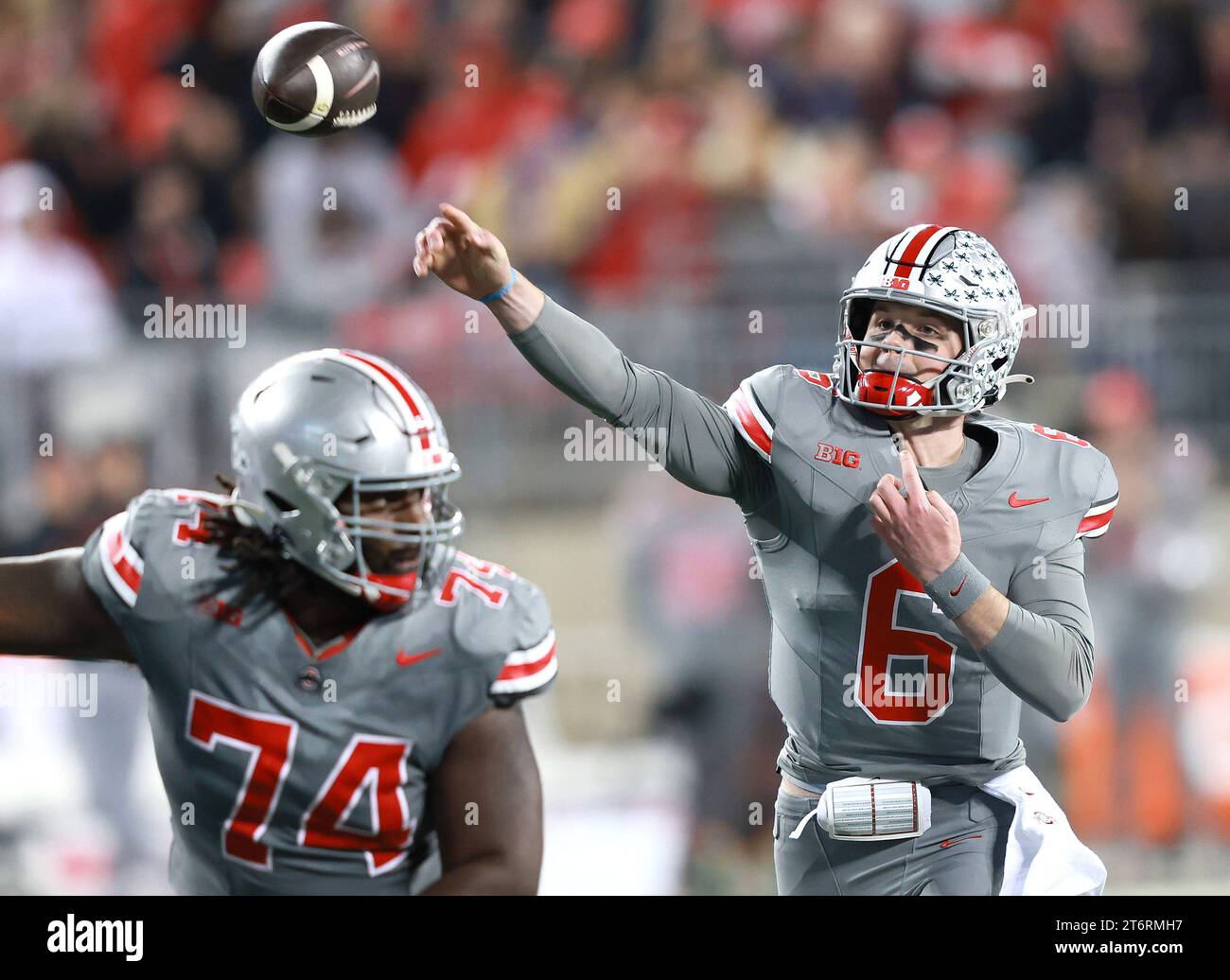 Ohio State Buckeyes quarterback Kyle McCord (6) throws a pass behind a
