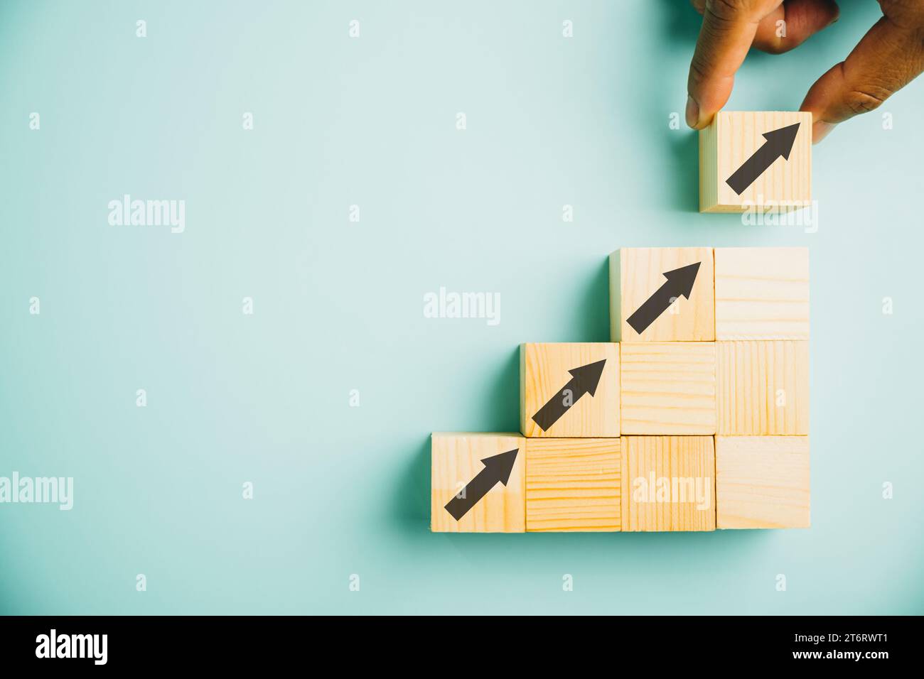 male hands stacking wooden blocks as steps on a white table Stock Photo ...