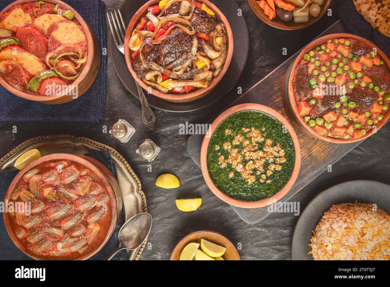 Arabic Cuisine; A variety of Middle Eastern traditional tagines such as potatoes, okra, peas, meat and molokhiya. Served with vermicelli rice. Stock Photo