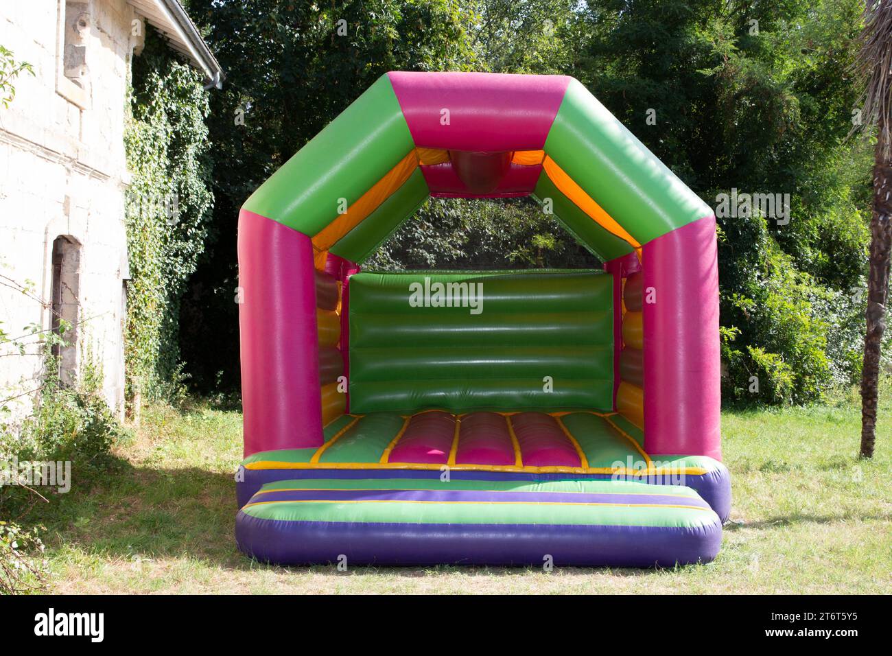 Inflatable slide house play for kids in playground Stock Photo - Alamy