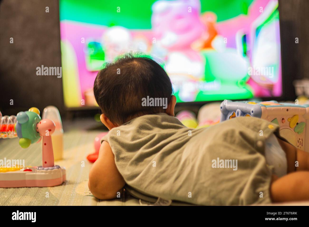 Baby Looking Television In Bedroom, background for advertisement and wallpaper in relaxation corner and home scene. Actual images in decorating ideas Stock Photo