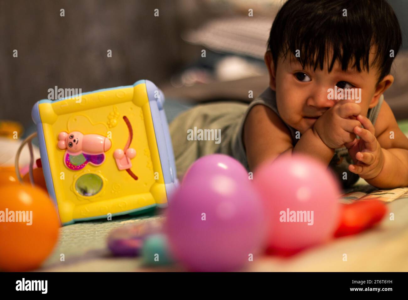 Child playing with colorful toy blocks. Kid playing in the room Stock