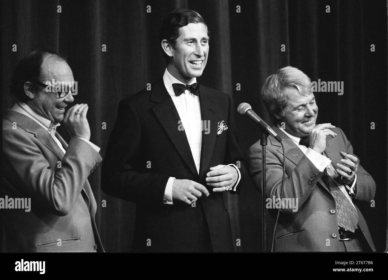 File photo dated 04/07/77 of the Prince of Wales on stage with comedy duo Eric Morecambe (left) and Ernie Wise, (right) during their special Royal Charity Show in aid of the Queen's Jubilee Appeal. Photos from every year of the King's life have been compiled by the PA news agency to celebrate King Charles III's 75th birthday. Issue date: Sunday November 12, 2023. Stock Photo