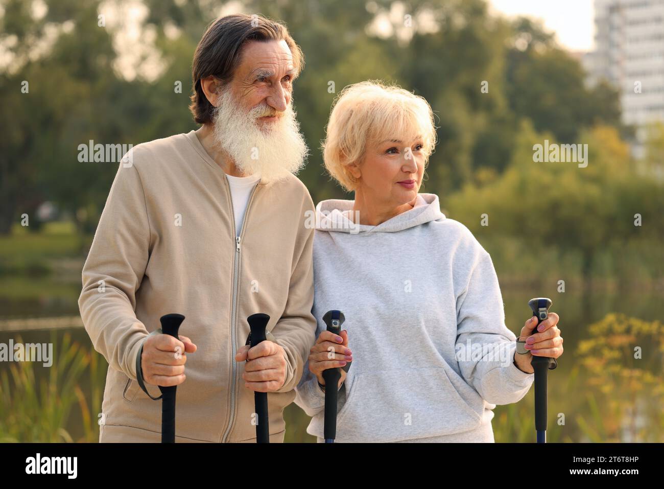 Senior man and woman with Nordic walking poles outdoors Stock Photo - Alamy