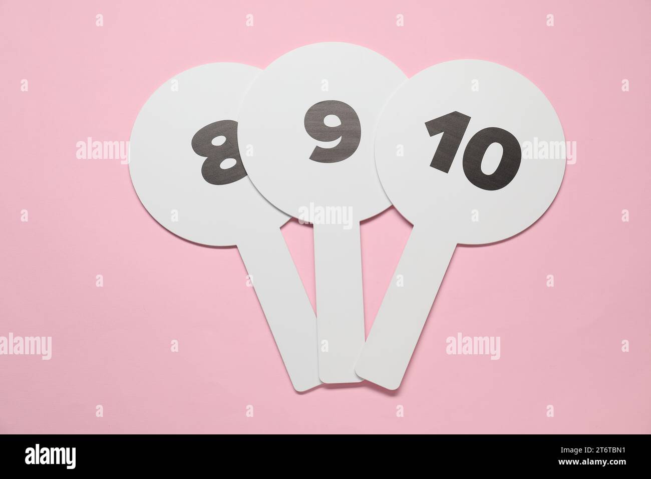 Auction paddles with numbers on pink background, top view Stock Photo -  Alamy