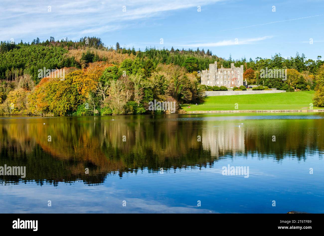 Castlewellan, County Down, Northern Ireland November 11 2023 - Castlewellan Castle seen from across the lake with reflections and Autumn colours Stock Photo