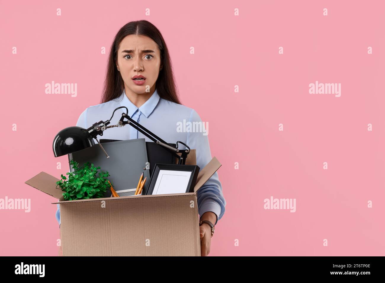 Unemployed Box Unemployment problem. Confused woman with box of personal office ...