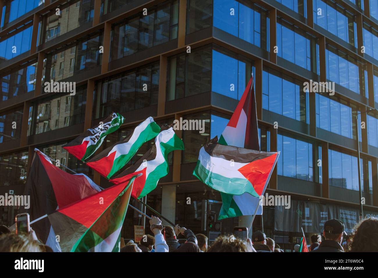 Palestinian flags are flown by protestors during the demonstration. A protest organised by the Palestine Solidarity Campaign protesting for a ceasefire and end to hostilities in Gaza held outside the US embassy in London. Vauxhall and Battersea area. Stock Photo