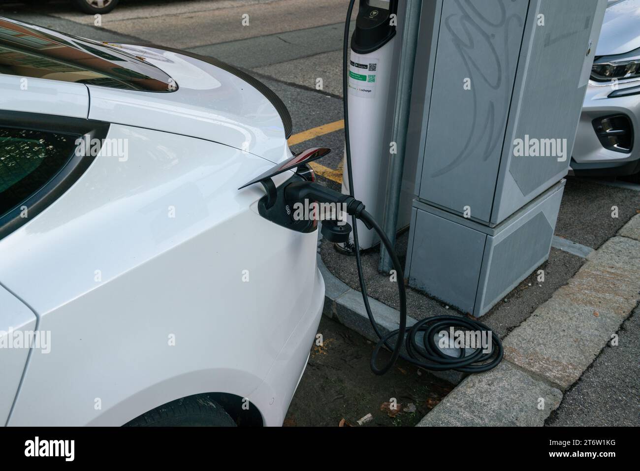 electric car charging, plug in to draw energy in the dedicated car park