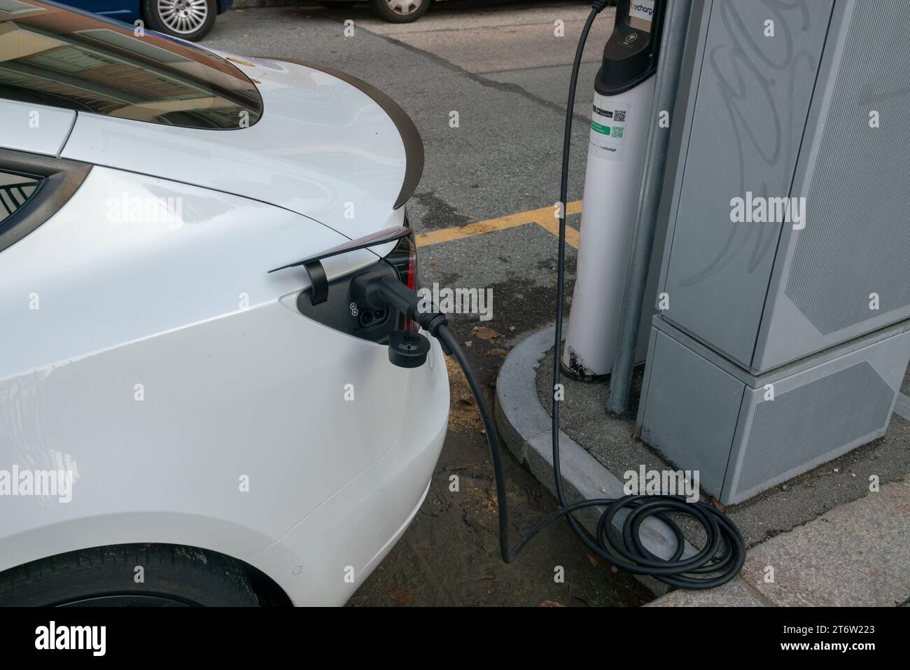 electric car charging, plug in to draw energy in the dedicated car park