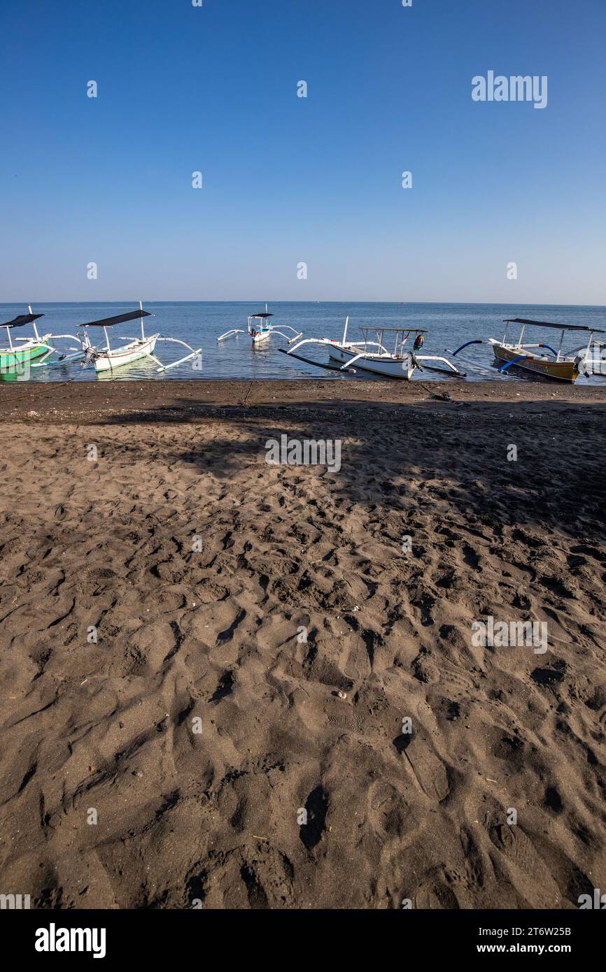 Jukung on the beach by the sea. Traditional fishing boat in the morning light. In Lovina, Bali Stock Photo